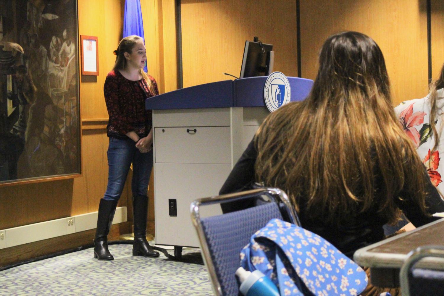 Ally Clark, a counter-protester during Monday's anti-Brett Kavanaugh protest, calls for Student Government Association Treasurer Kristina DeVivo's impeachment as DeVivo watches.
