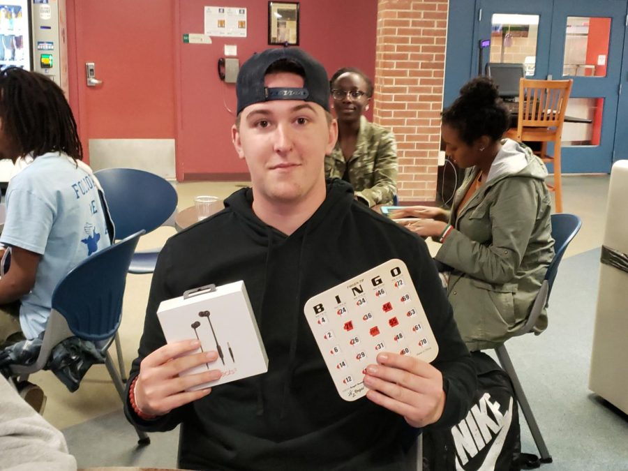 Winner Tanner Kingsley posing with winning card and Beats Headphones