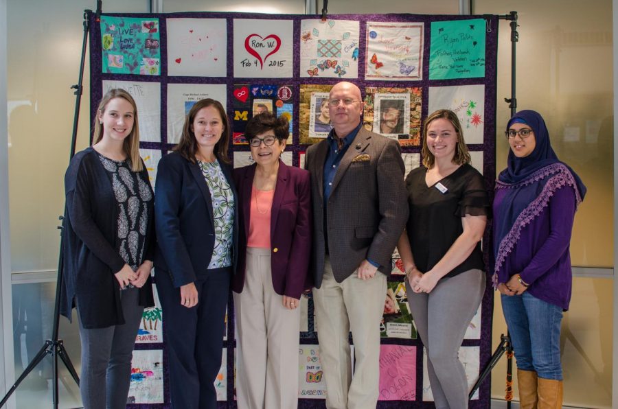 President Toro and the events organizers in front of the quilt.