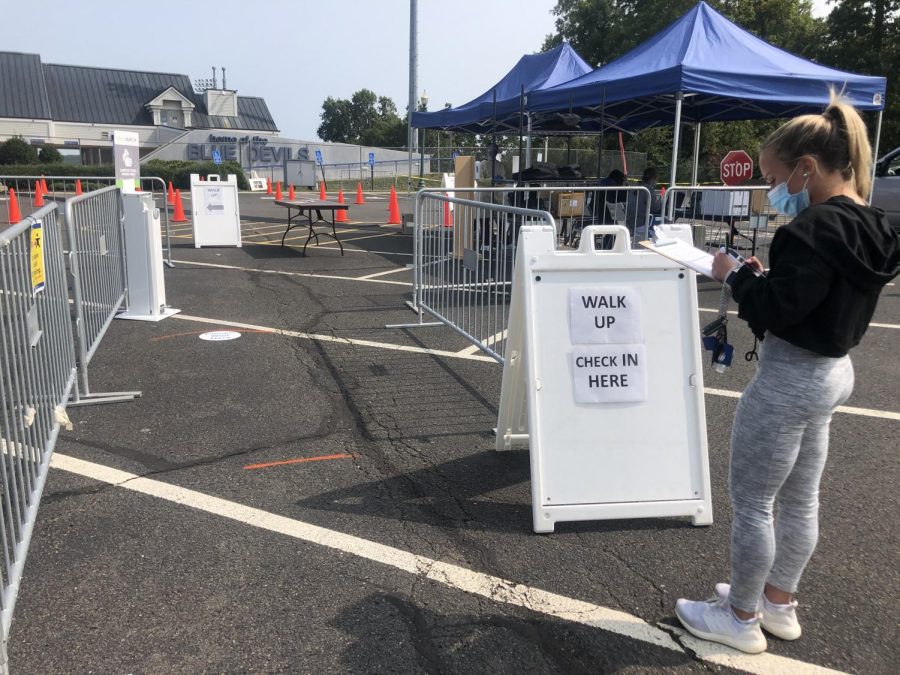 CCSU senior, Cayla Balzarini, fills out paperwork to receive a free coronavirus test in Kaizer Lot.