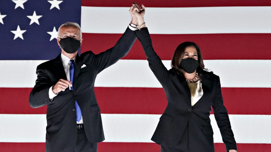 Former Vice President Joe Biden, Democratic presidential nominee, left, and Senator Kamala Harris, Democratic vice presidential nominee, wear protective masks while holding hands outside the Chase Center during the Democratic National Convention in Wilmington, Delaware, U.S., on Thursday, Aug. 20, 2020. Biden accepted the Democratic nomination to challenge President Donald Trump, urging Americans in a prime-time address to vote for new national leadership that will overcome deep U.S. political divisions. Photographer: Stefani Reynolds/Bloomberg via Getty Images