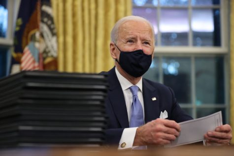 President Joe Biden prepares to sign a series of executive orders at the Resolute Desk in the Oval Office just hours after his inauguration, Jan. 20, 2021, in Washington, D.C.(CHIP SOMODEVILLA/GETTY IMAGES