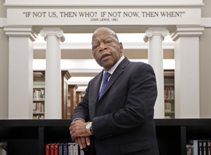 Rep. John Lewis, D-Ga., poses for a photograph under a quote of his that is displayed in the Civil Rights Room in the Nashville Public Library Friday, Nov. 18, 2016, in Nashville, Tenn. Lewis will be honored this weekend in Nashville, where the civil rights leader once organized sit-ins at the citys segregated lunch counters. Lewis is being recognized with the Nashville Public Library Literary Award. (AP Photo/Mark Humphrey)