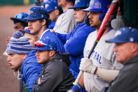 Central Connecticut State University baseball players watch from the dugout on Saturday, March 19, in Auburndale, FL.