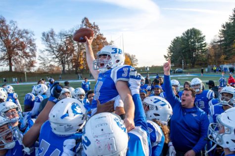 The CCSU football team lifts kicker Joe Zoppi in celebration after he hit a game winning kick at Arute Field on Saturday, Nov. 20, 2021. 