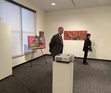 Visitors look at Rachel Siporin’s artwork.