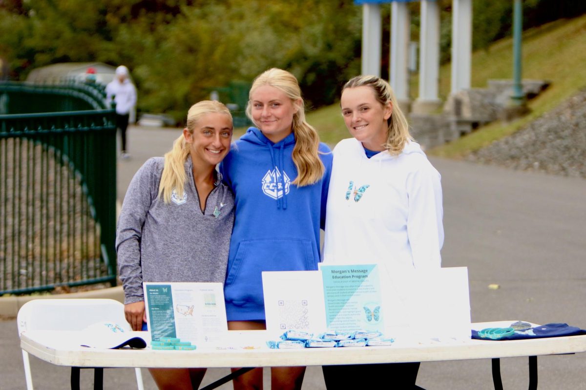 (from left) Central women's soccer players Rachel Wygant and Riley Powers, and softball player Abby Meehan tabling for Morgan's Message.