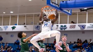 Abdul Momoh after dunking during Thursday's 84-75 win over Le Moyne.