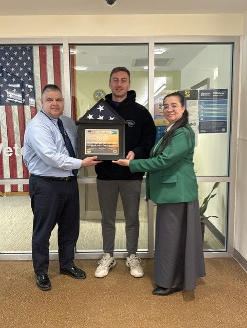 Max Chiarillo (middle) dedicated the flag that he flew over the Horn of Africa to CCSU's VA office 